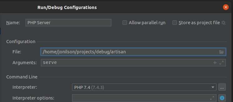 Alt: print de tela “Run/Debug Configurations” do Intellij Idea em fundo preto, com o campo “Name” preenchido com o nome “PHP Server”, logo abaixo na seção “Configuration” o campo file preenchido com o valor “/home/jonilson/projects/debug/artisan” e logo abaixo no campo “Arguments” preenchido com o valor “serve” e por fim na seção “Command Line” o campo “Interpreter” é preenchido com o valor “PHP 7.4 (7.4.3)” representando as configurações necessárias para a criação de execução da aplicação no editor.