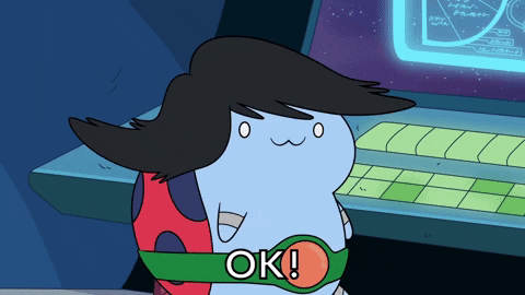 Personagem azul com um corte de cabelo estiloso, vestindo um cinto verde e vermelho, apertando um botão em um painel futurista. A palavra 'OK!' aparece na tela, indicando que a ação foi concluída com sucesso.